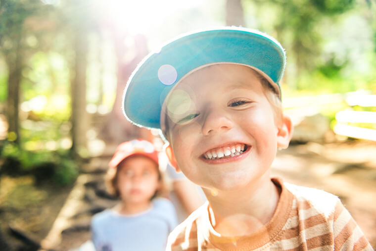 Young boy in cap, smiling